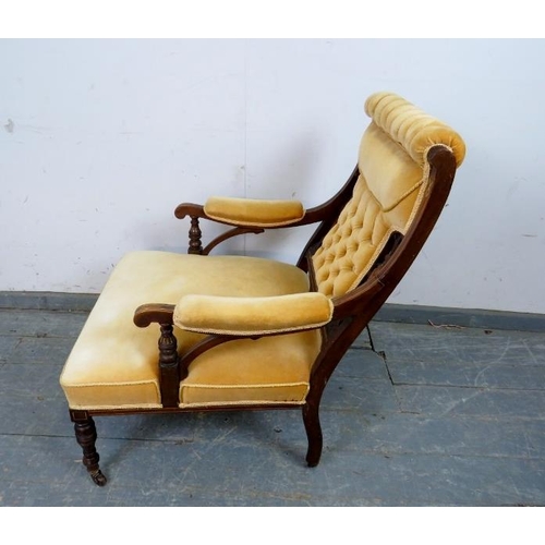 720 - An Edwardian mahogany low library chair, the carved and pierced back with marquetry inlay, reupholst... 