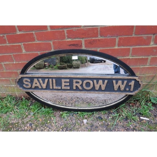 723 - An antique oval bevelled wall mirror, within an ebonised and parcel gilt frame with added ‘Saville R... 