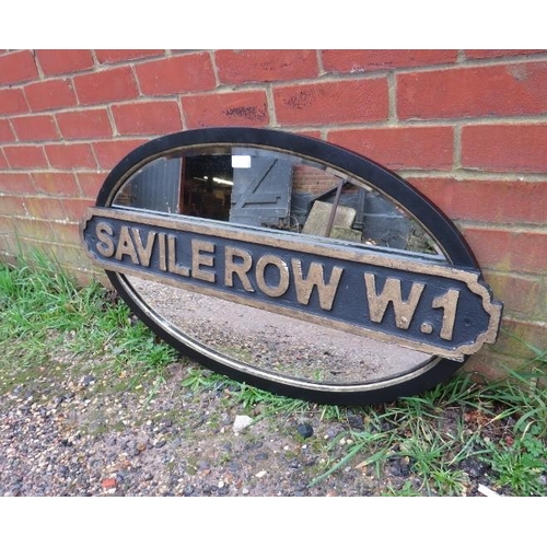 723 - An antique oval bevelled wall mirror, within an ebonised and parcel gilt frame with added ‘Saville R... 