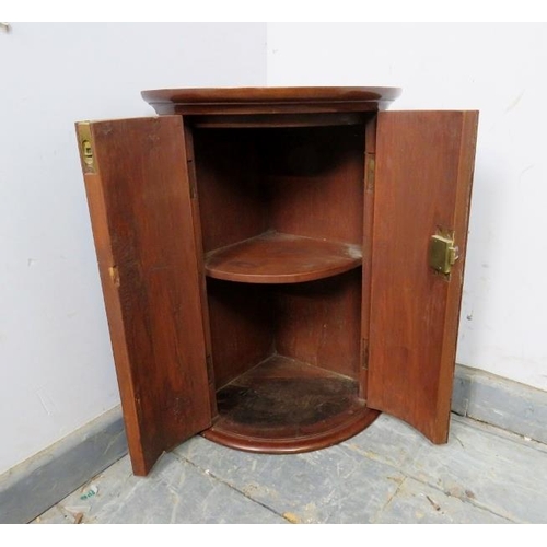 727 - A George III flame mahogany bow-fronted hanging corner cupboard of diminutive proportions, having a ... 