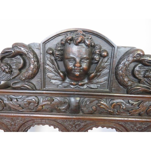 728 - A 19th century Gothic revival oak hall bench, having turned finials and profuse acanthus leaf decora... 