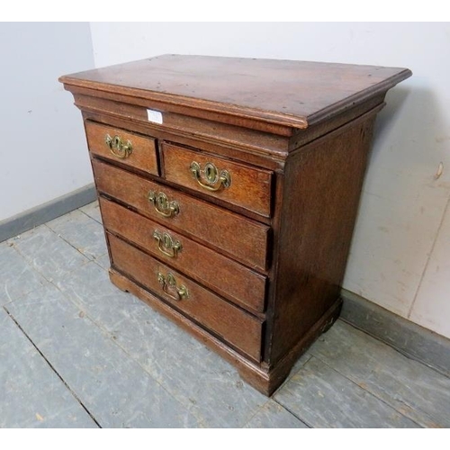 731 - A diminutive 18th century oak chest, housing two short over three long graduated cock-beaded drawers... 