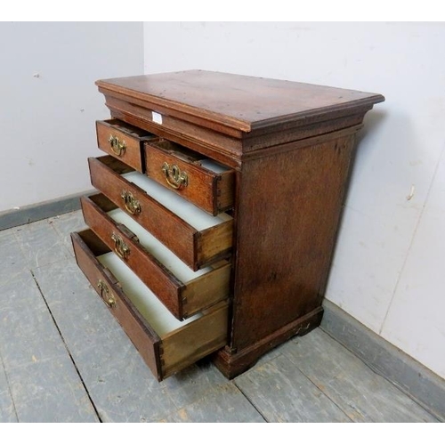 731 - A diminutive 18th century oak chest, housing two short over three long graduated cock-beaded drawers... 