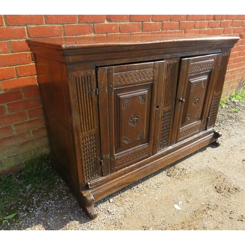 734 - An exceptional early 17th century Continental oak sideboard, probably Dutch, having two doors with f... 