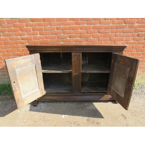 734 - An exceptional early 17th century Continental oak sideboard, probably Dutch, having two doors with f... 