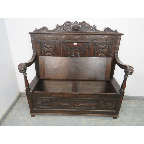 735 - A 19th century Gothic Revival oak settle, the backrest with relief carved decoration depicting taver... 