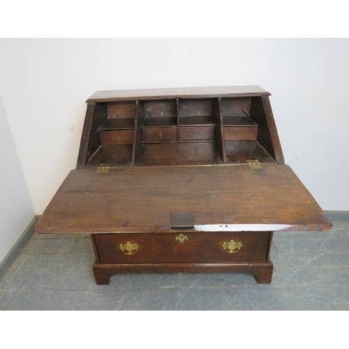 738 - A late 17th century oak bureau of good colour, the fall front opening onto a fitted interior with ce... 