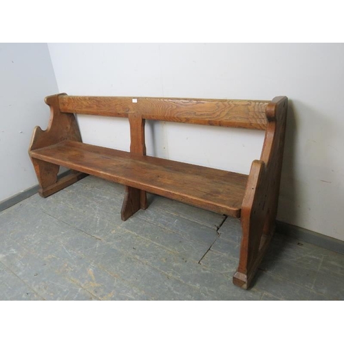 739 - An antique elm & pitch pine pew/hall bench, having carved end supports in the manner of Pugin. 
H80c... 