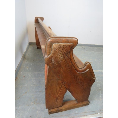 739 - An antique elm & pitch pine pew/hall bench, having carved end supports in the manner of Pugin. 
H80c... 