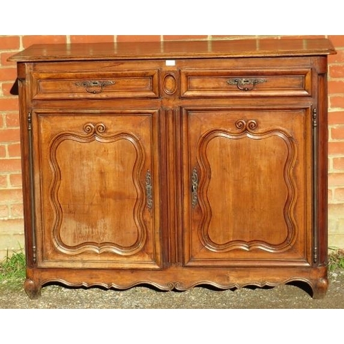 741 - An 18th century and later French fruitwood sideboard, housing two short drawers above cupboards with... 