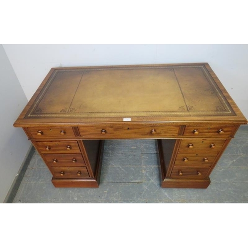 749 - A 19th century walnut pedestal desk, having inset gilt tooled brown leather writing surface, above a... 