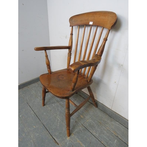 752 - A 19th century elm & beech Windsor fireside chair, on canted turned supports with an ‘H’ stretcher. ... 