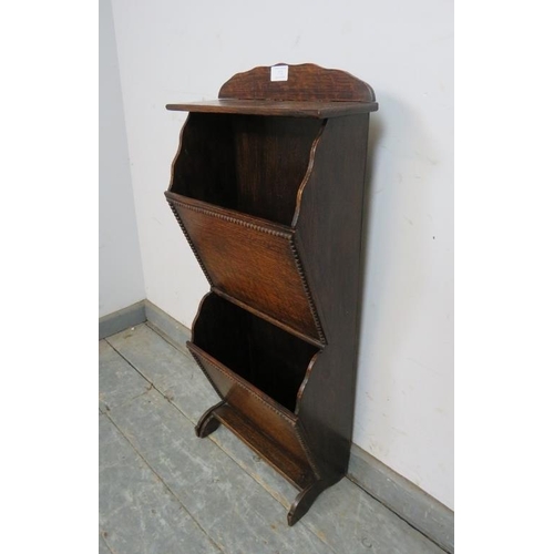 772 - A 1920s oak waterfall freestanding ‘Homettes’ magazine rack, on curved supports. 
H80cm W36cm D17cm ... 