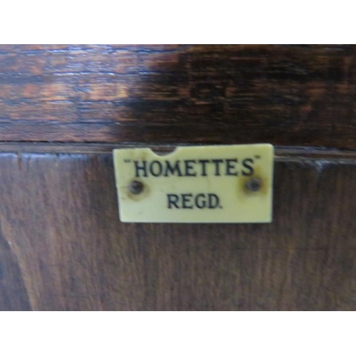 772 - A 1920s oak waterfall freestanding ‘Homettes’ magazine rack, on curved supports. 
H80cm W36cm D17cm ... 