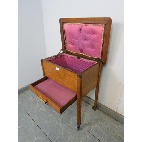 773 - An Art Deco Period medium oak sewing box, having a silk lined storage well above one long drawer, on... 