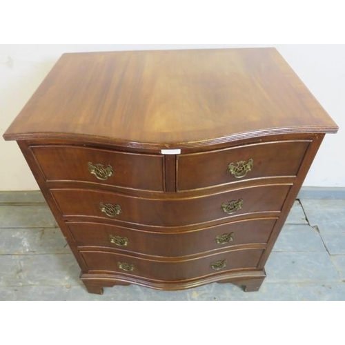 776 - A reproduction mahogany serpentine chest in the Georgian taste, having two short and three long grad... 