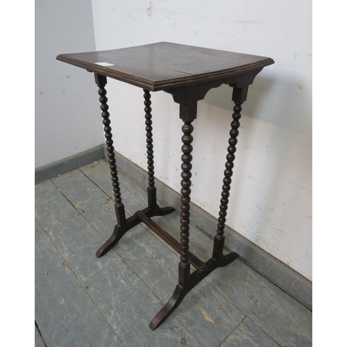 779 - A 1920s oak occasional table, on bobbin turned supports with splayed feet and middle stretcher. 
H64... 