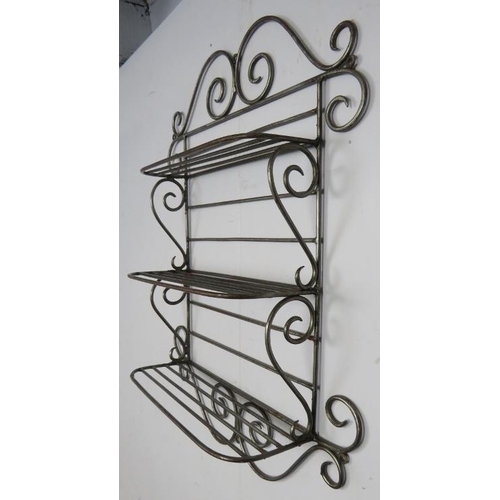 792 - A vintage wall hanging wrought steel kitchen shelving unit of three open shelves, with scrolled deco... 