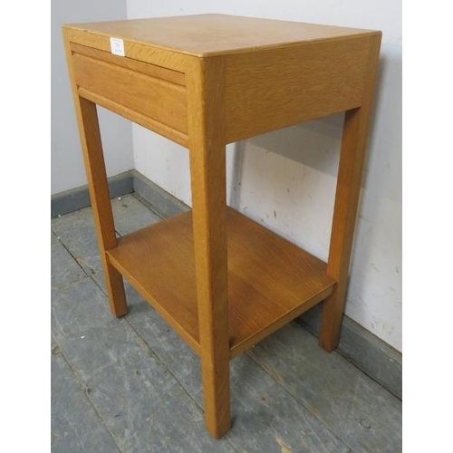 793 - A mid-century light oak two-tier side table with blind frieze drawer, on square supports. 
H61cm W40... 