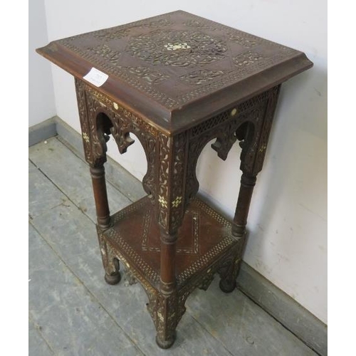 797 - An antique Islamic hardwood two-tier occasional table, having profuse relief carved decoration and m... 