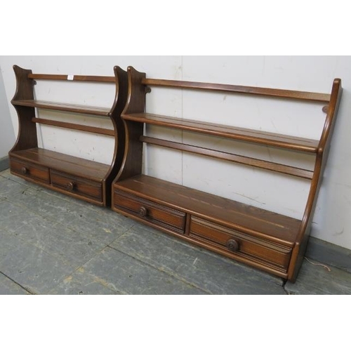 799 - A pair of vintage ash wall hanging waterfall shelving units by Ercol, each having two open shelves a... 