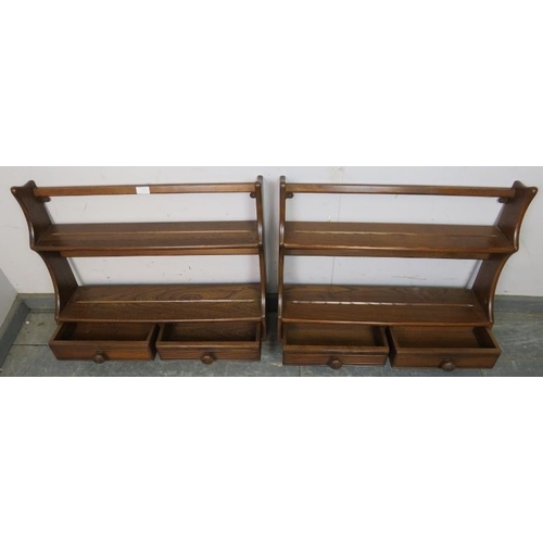 799 - A pair of vintage ash wall hanging waterfall shelving units by Ercol, each having two open shelves a... 