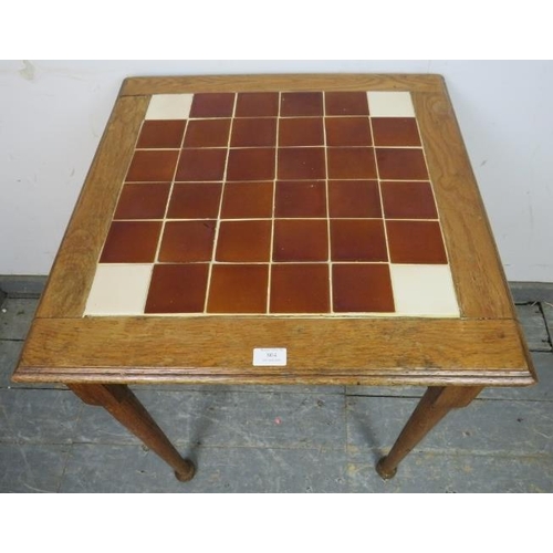 804 - An antique medium oak square table, with inset tile top, on tapering supports with pad feet.
H72cm W... 