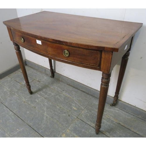 806 - A George IV mahogany bow-fronted hall table, strung with ebony and satinwood, housing one long drawe... 