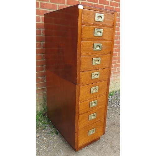 810 - A vintage flight of nine graduated drawers with brass campaign style handles, on a plinth base with ... 