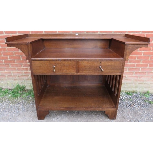 814 - An Arts & Crafts oak buffet sideboard by Liberty & Co, having a ¾ shelved gallery above two short dr... 