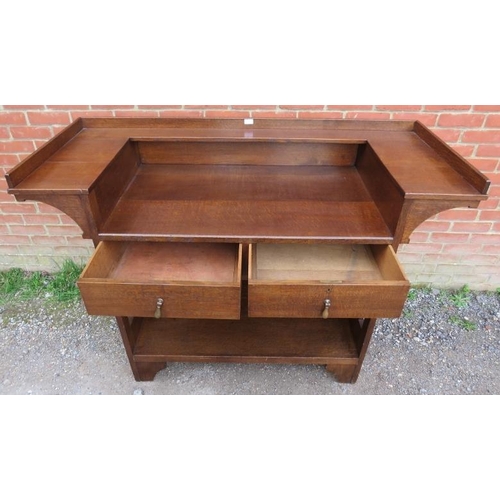 814 - An Arts & Crafts oak buffet sideboard by Liberty & Co, having a ¾ shelved gallery above two short dr... 