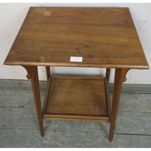 815 - An Arts & Crafts walnut two-tier occasional table, having shaped corner brackets, on canted tapering... 