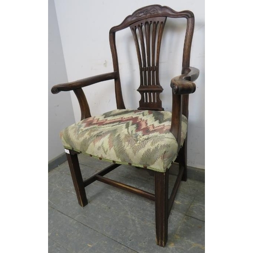 819 - A Georgian mahogany elbow chair, having a shaped and pierced backsplat, joined with scrolled armrest... 