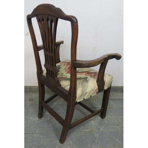 819 - A Georgian mahogany elbow chair, having a shaped and pierced backsplat, joined with scrolled armrest... 