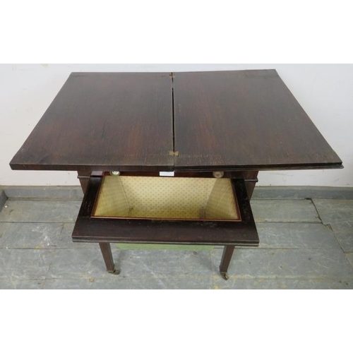 821 - A Regency Period rosewood turnover worktable, the folding top over one long frieze drawer with inter... 