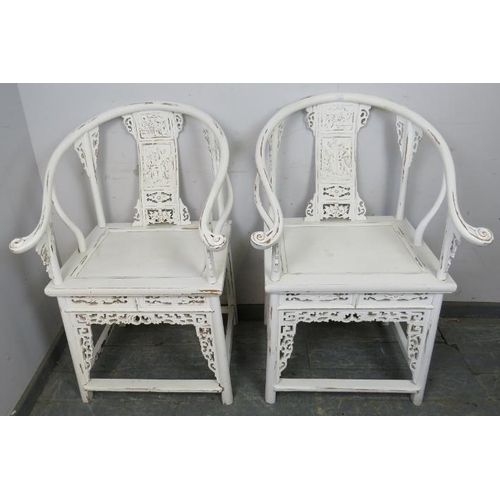 822 - A pair of vintage Chinese horseshoe chairs in the 18th century taste, painted white and distressed, ... 