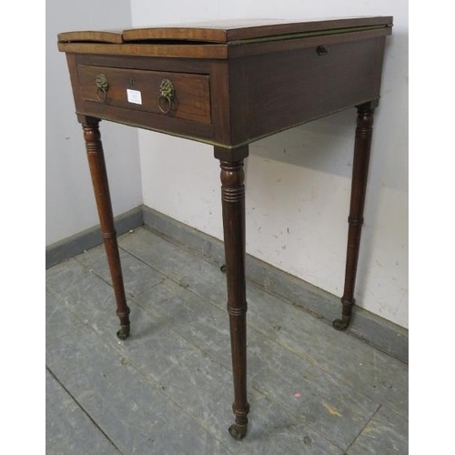 823 - A Regency Period mahogany card table, the folding top with brass and ebony inlaid border, above one ... 