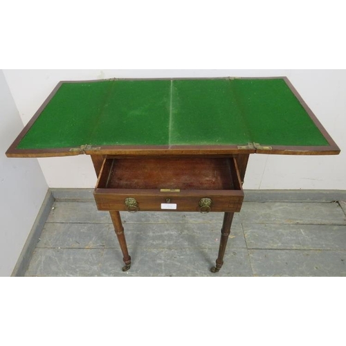 823 - A Regency Period mahogany card table, the folding top with brass and ebony inlaid border, above one ... 