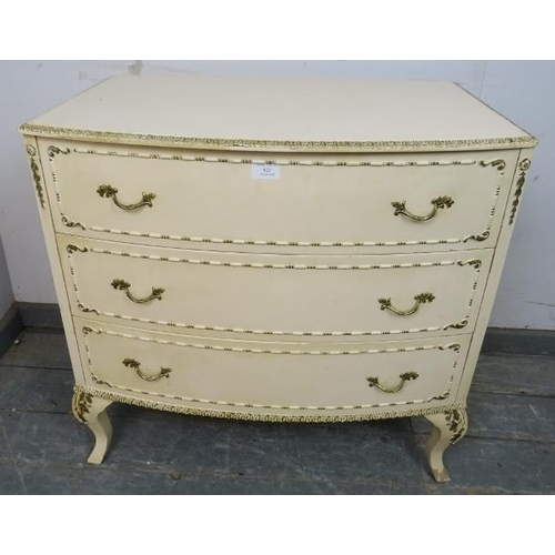 825 - A vintage French bow-fronted chest in the Louis XV taste, painted cream and gold, housing three long... 