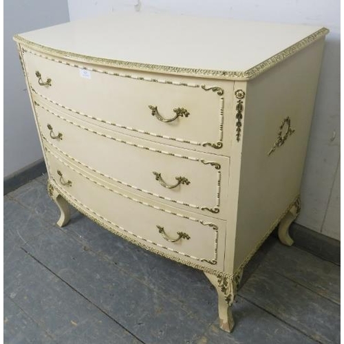 825 - A vintage French bow-fronted chest in the Louis XV taste, painted cream and gold, housing three long... 