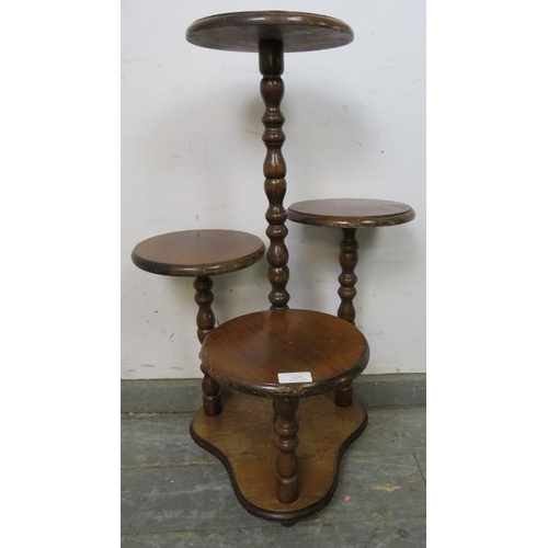 828 - A vintage mahogany asymmetrical four tier display/plant stand with bobbin turned uprights, on a tref... 