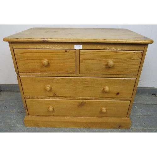 829 - A small vintage pine chest, housing two short over two long drawers with turned wooden handles, on a... 