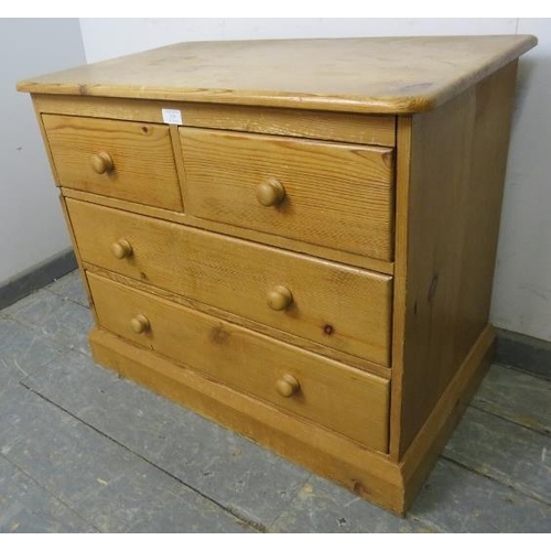 829 - A small vintage pine chest, housing two short over two long drawers with turned wooden handles, on a... 