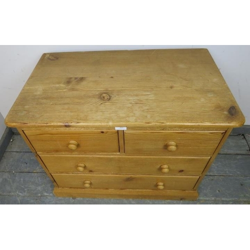 829 - A small vintage pine chest, housing two short over two long drawers with turned wooden handles, on a... 