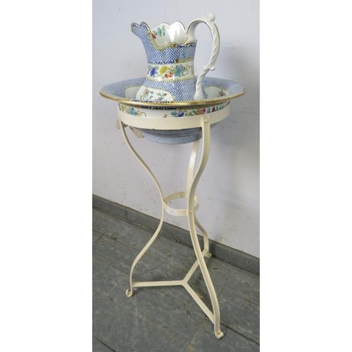 831 - A 19th century metal washstand, with accompanying Copeland jug and bowl, on scrolled tripod supports... 