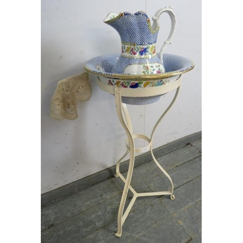 831 - A 19th century metal washstand, with accompanying Copeland jug and bowl, on scrolled tripod supports... 