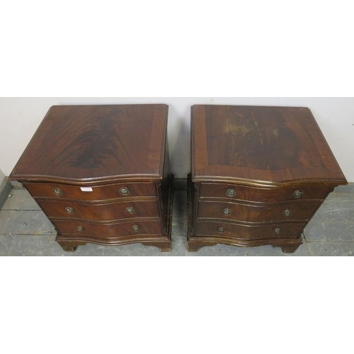 833 - A pair of reproduction mahogany serpentine fronted bedside chests in the Georgian taste, each housin... 