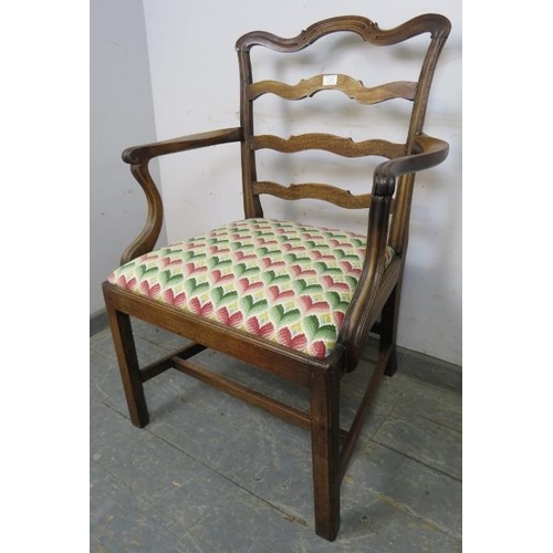 838 - A Georgian mahogany elbow chair, having shaped ladder-back and scrolled armrests, the drop-in seat p... 