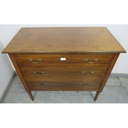 843 - An Edwardian mahogany chest housing three long drawers with fancy brass handles and inlaid brass ban... 