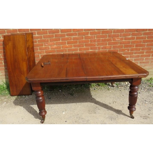 847 - A Regency Revival mahogany wind-out extending dining table, with two additional leaves, on turned an... 